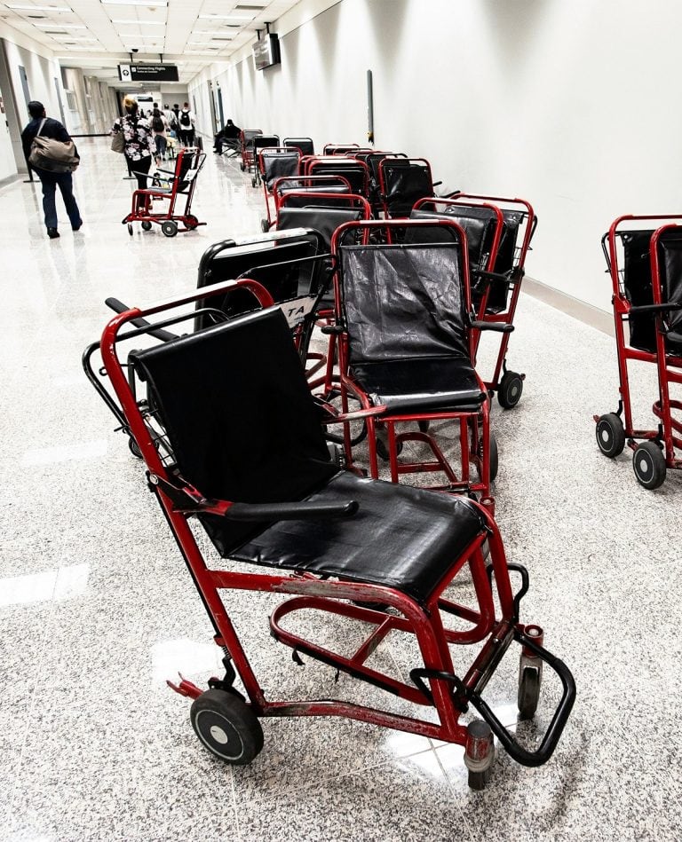 Lots of wheelchairs are in an airport.